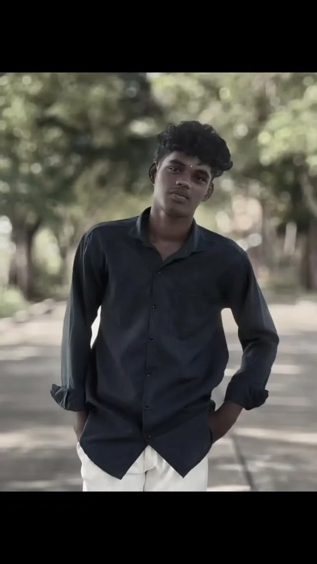 posing in a green park with blurred bokeh