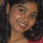 Anupama resting on a park bench with a helmet placed next to her