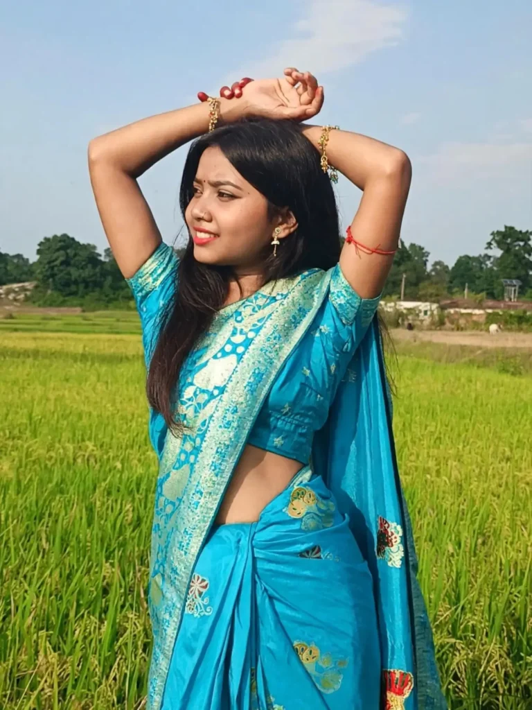 Anupama female rider style photo sitting beside a volt motorcycle helmet